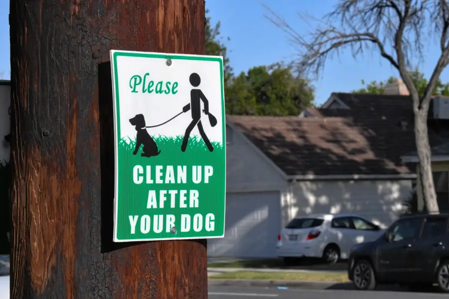 Please clean up after your dog sign